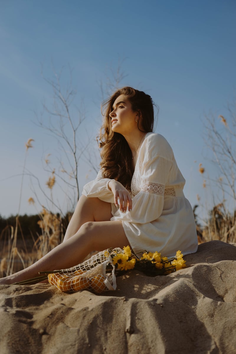 Woman in White Shirt Sitting on Rock